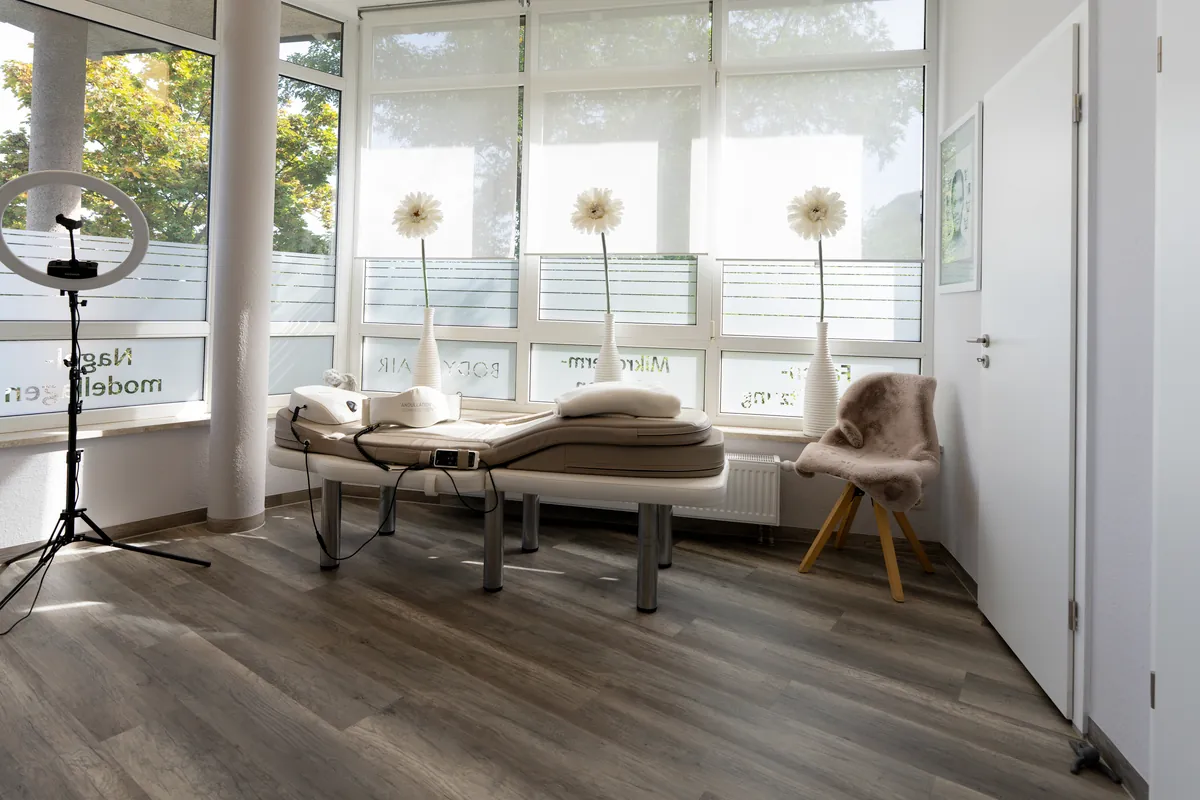 Behandlungsliege am Fenster mit Ringlicht bei BodyFlair Werdau